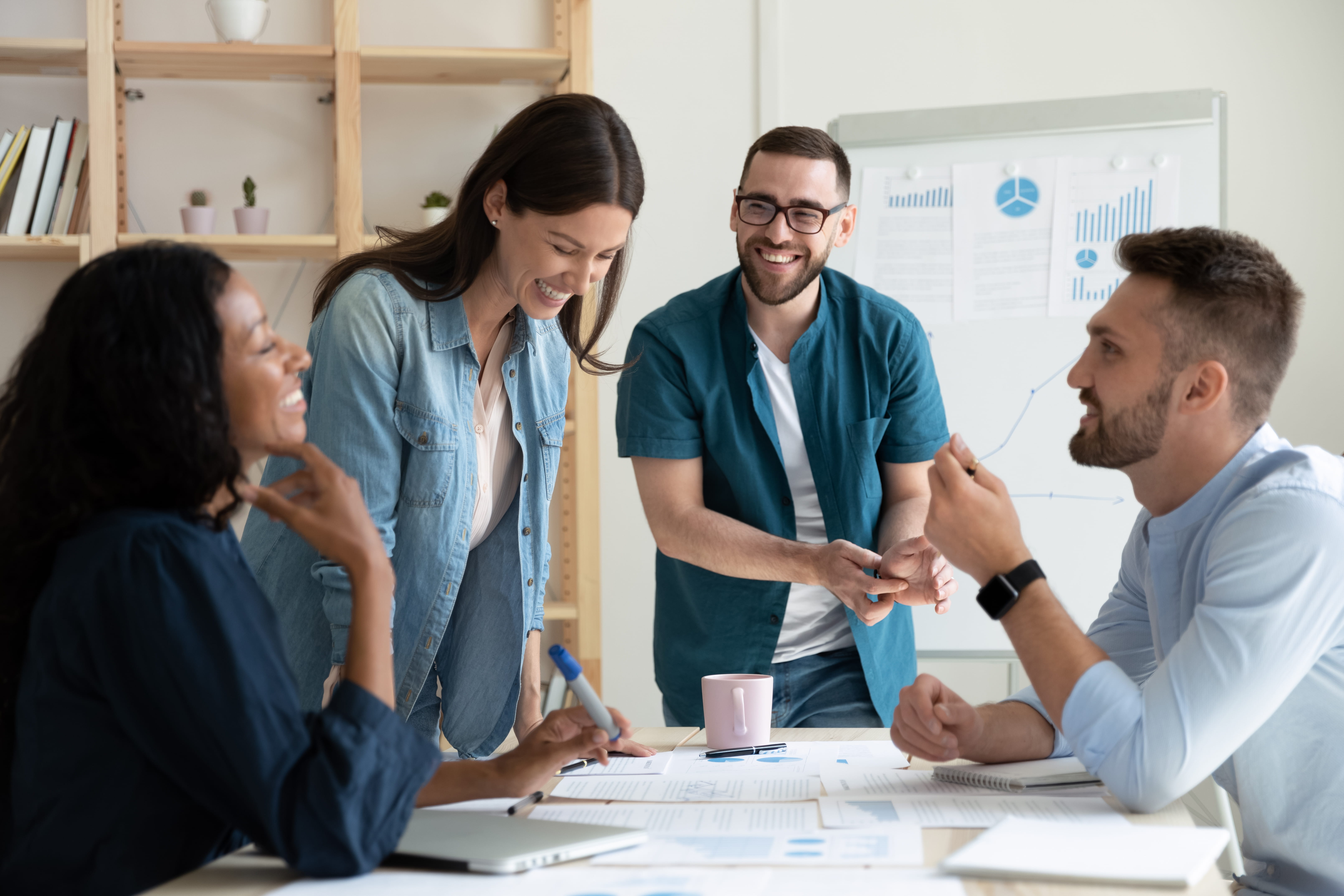 Hiring manager, recruiter and team members discuss job applicants they had just interviewed.