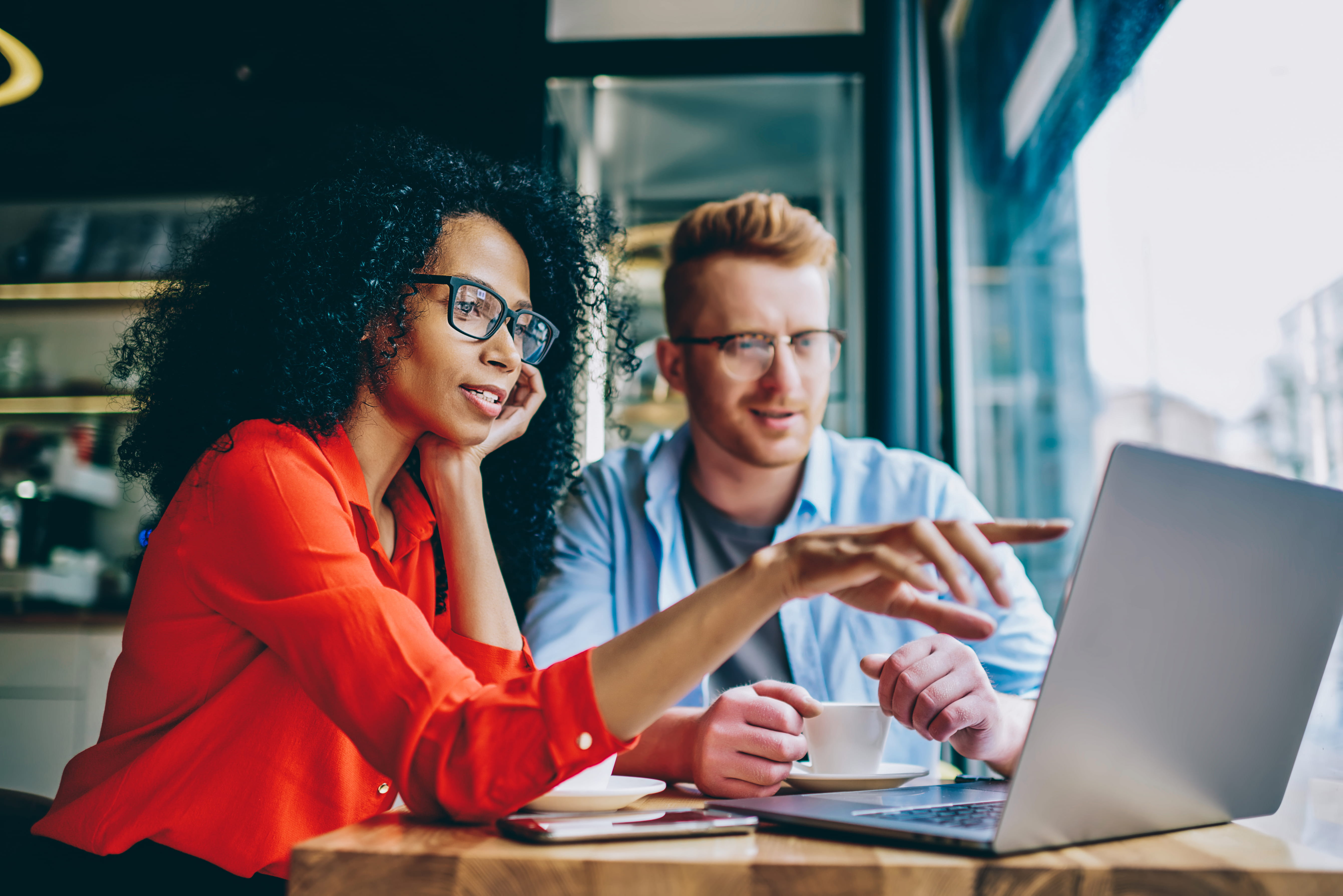 man and woman looking at laptop screen