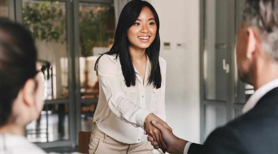 Smiling interviewer shaking hands with a job candidate