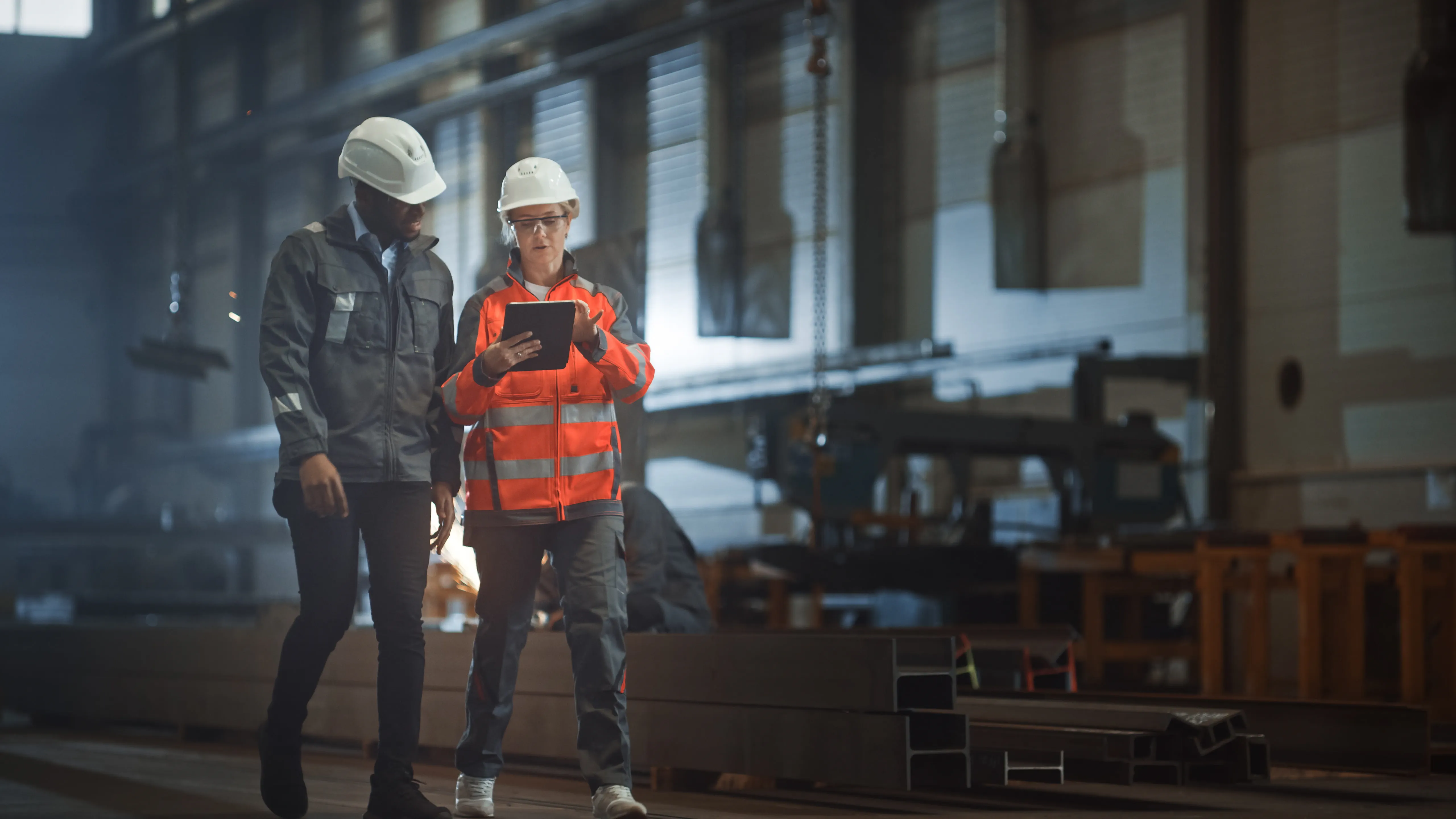 Two Heavy Industry Engineers Walk in Steel Factory